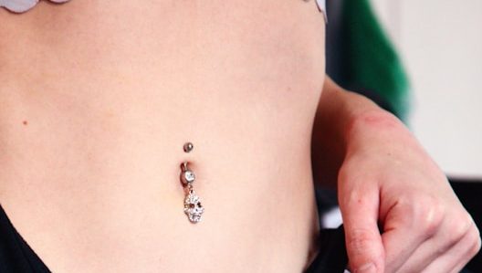 woman in black brassiere with tattoo on her back